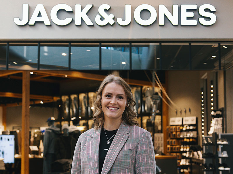 Jack & Jones retail store with large touchscreen displays and customers browsing clothing collections